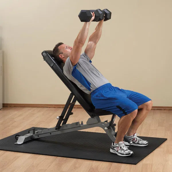 A man doing inclined dumbbell presses on the Body-Solid FID Bench SFID325