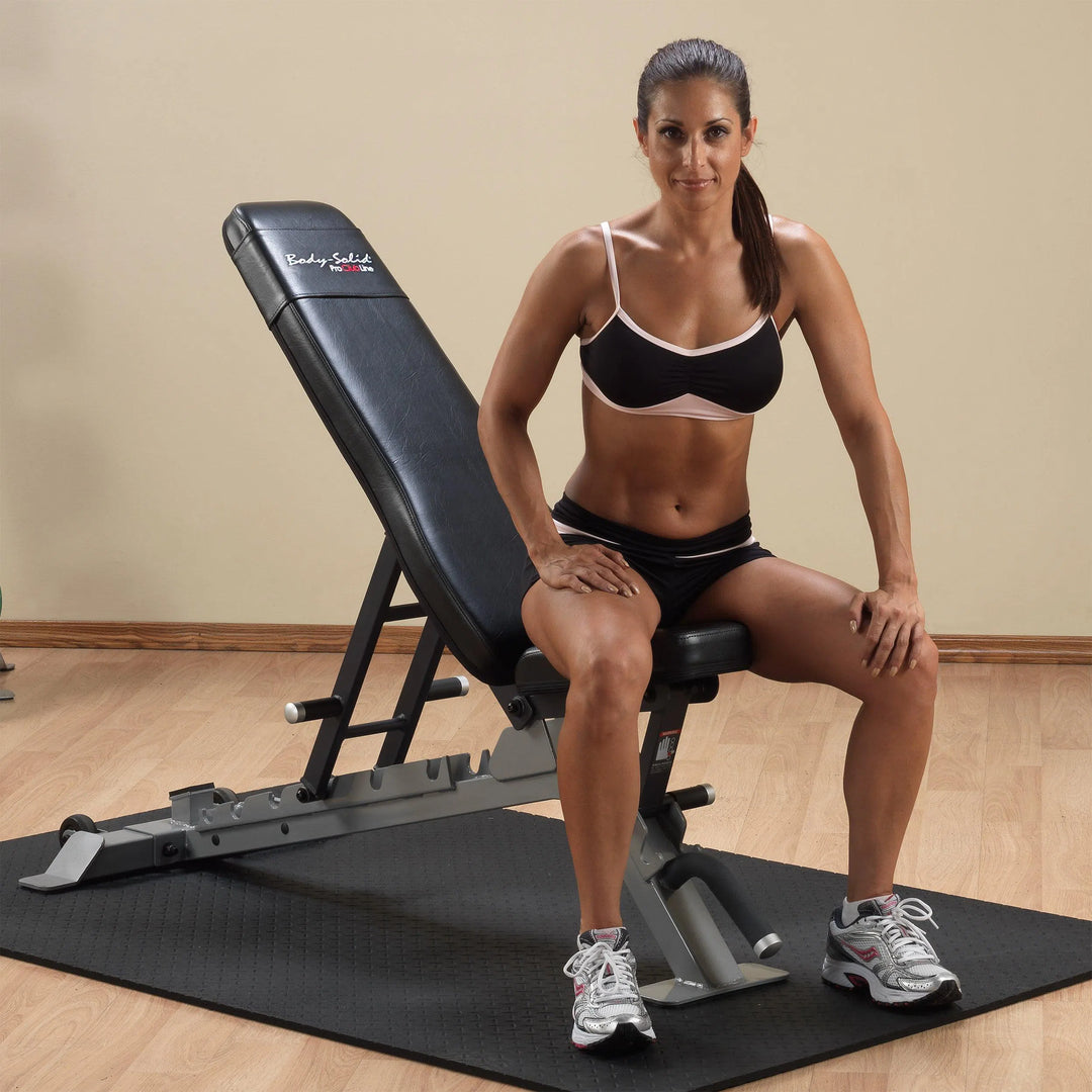 A woman showcasing the Body-Solid FID Bench SFID325