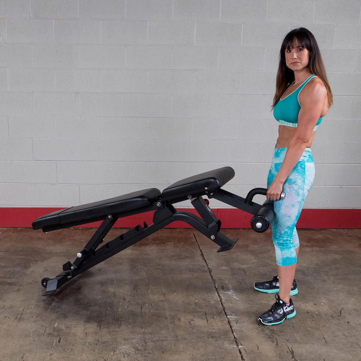 A woman preparing to train on the Body-Solid Commercial Adjustable Weight Bench SFID425