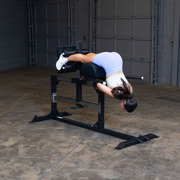 A woman doing back workouts on Body-Solid Back Hyperextension SGH500