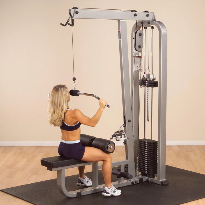 A woman training on the Body-Solid Lat Pulldown and Row Machine SLM300G