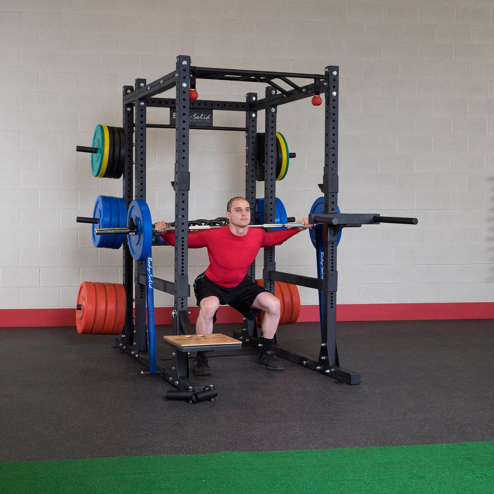 A man training on the Body-Solid Commercial Power Rack Extended SPR1000Back