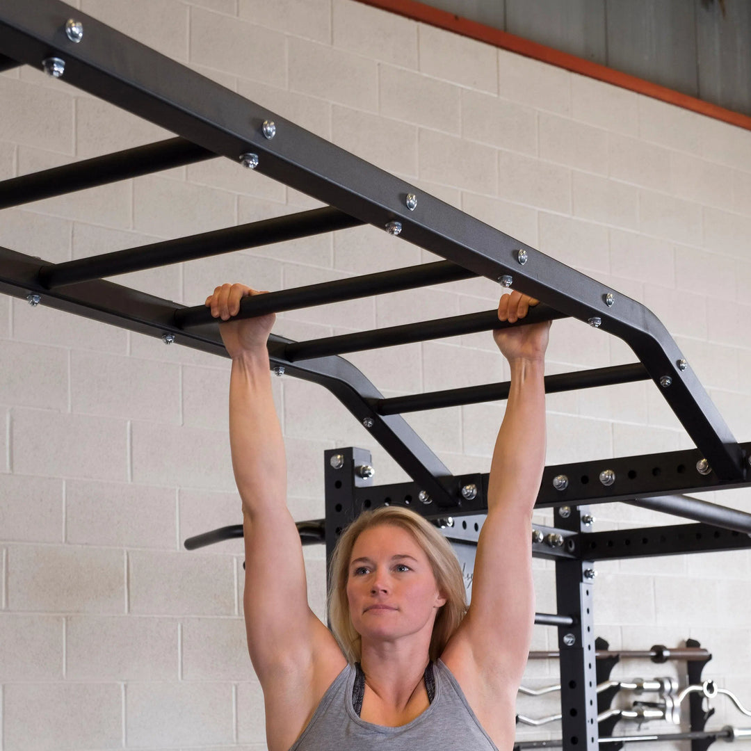 woman swinging on monkey bars on Body-Solid Double Power Rack SPR1000DB