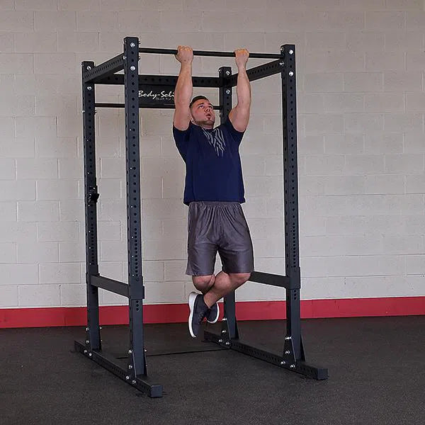 A man doing chin ups on the Body-Solid Commercial Power Rack SPR1000
