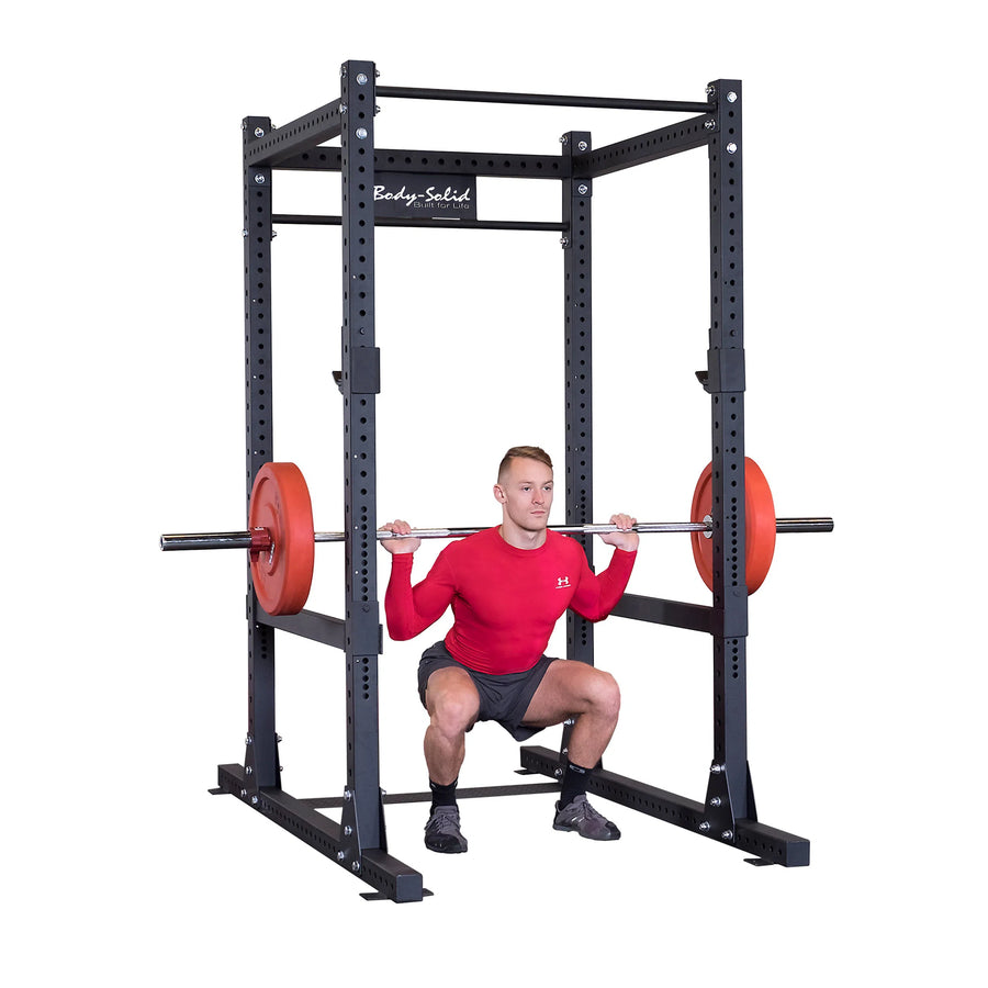 man back squats on Body-Solid Commercial Power Rack SPR1000