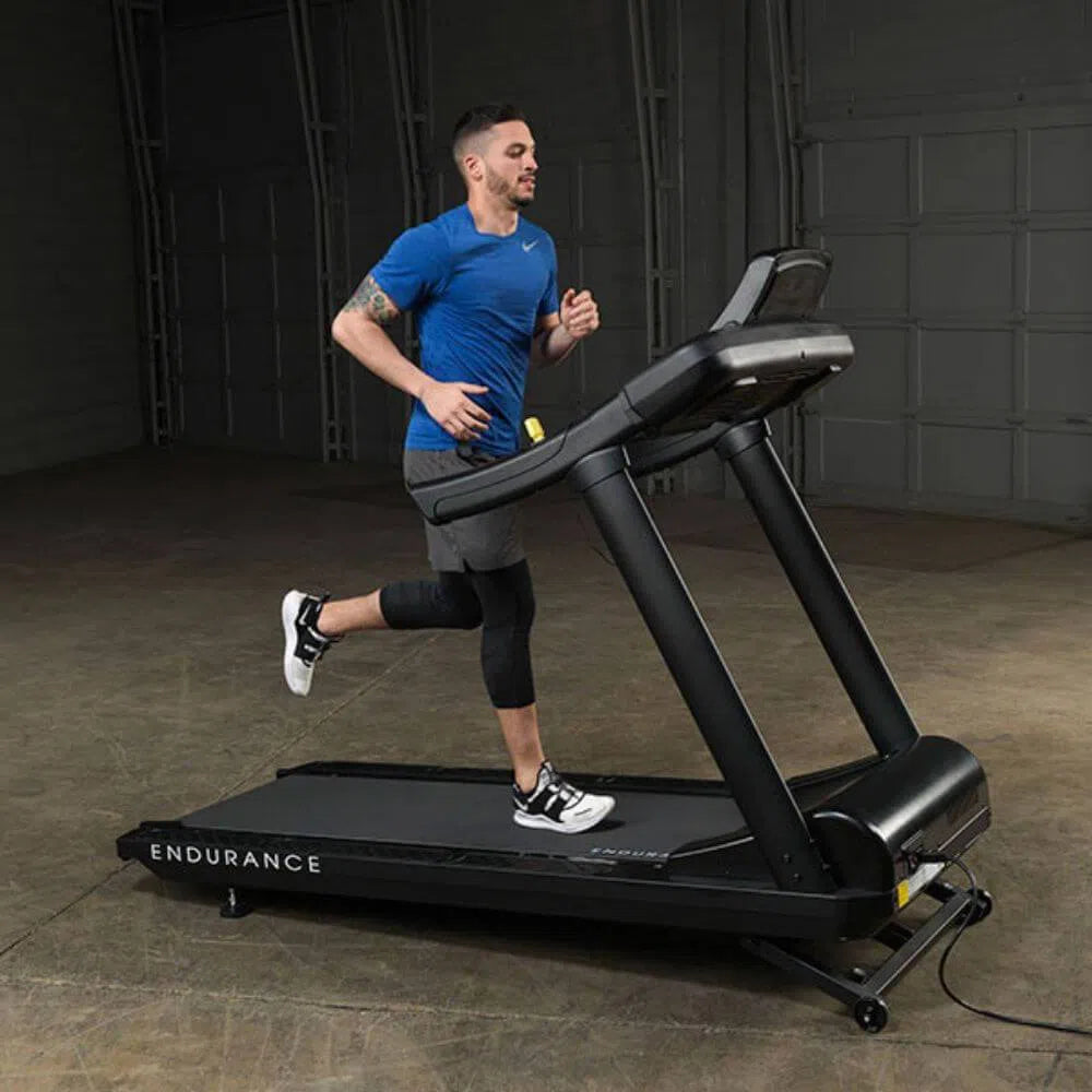 fit man running on Body-Solid Endurance Commercial Grade Treadmill T150
