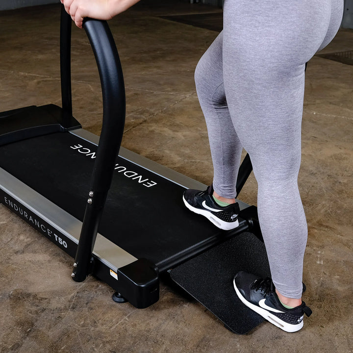 woman stepping up on Body-Solid Endurance Walking Treadmill T50
