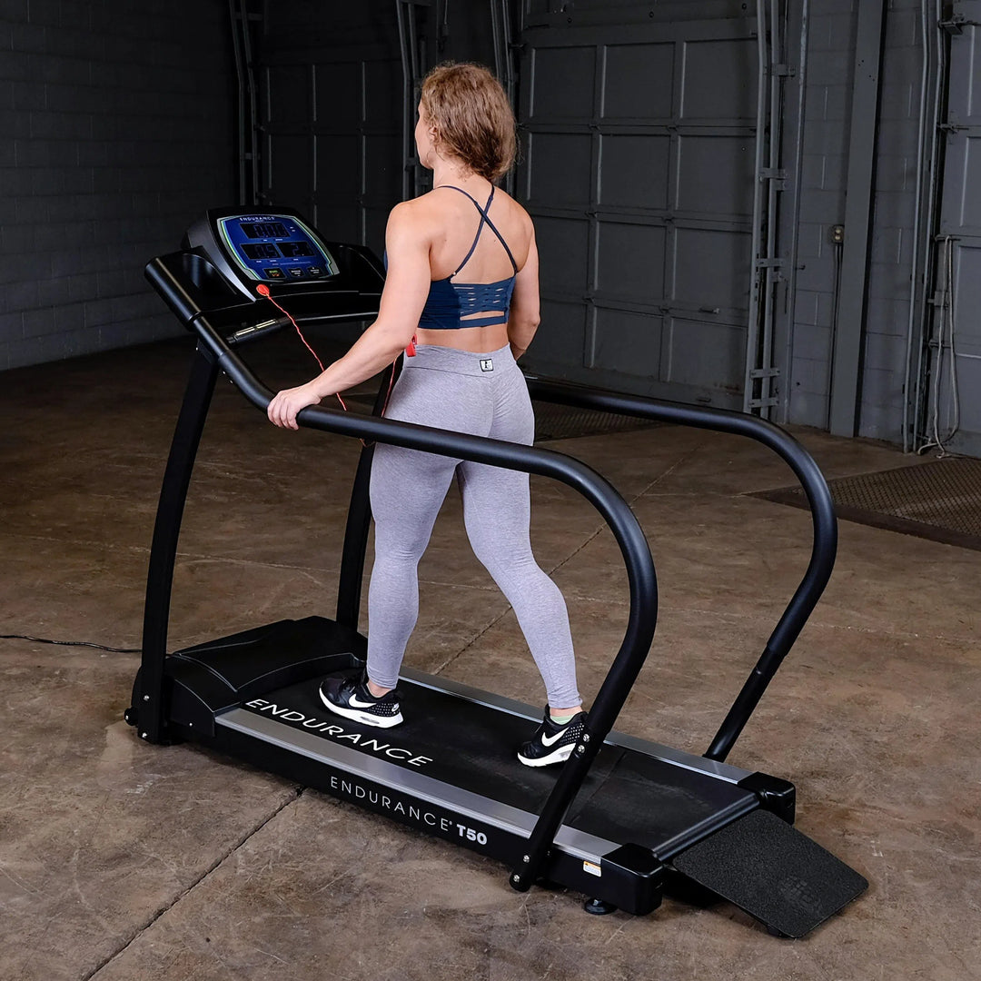 young woman walking workout on Body-Solid Endurance Walking Treadmill T50
