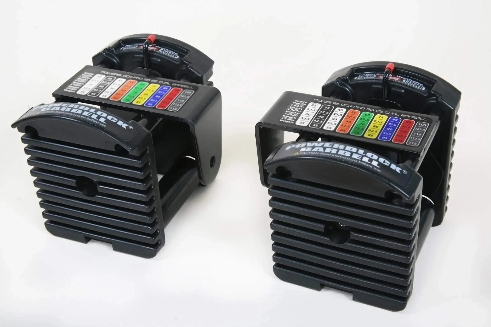 The PowerBlock Pro Series Barbell features sleek, adjustable dumbbells with a black plastic casing and a colorful weight selection panel for modern elegance. The visible PowerBlock brand and an easy-adjust handle evoke professional knurled bar craftsmanship against the plain white background.