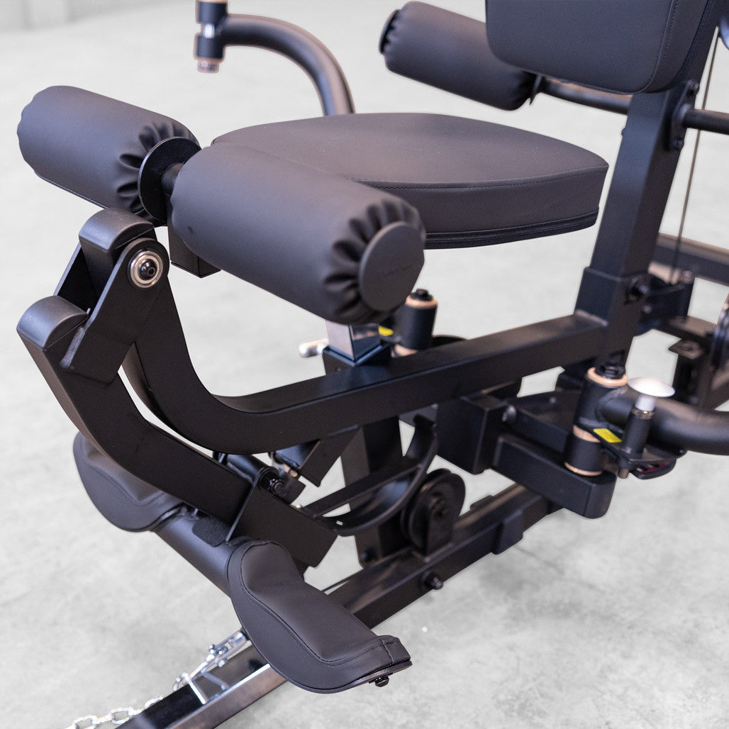 Close up of the Body-Solid G6B leg developer showing the DuraFirm roller pads, seat and ankle strap