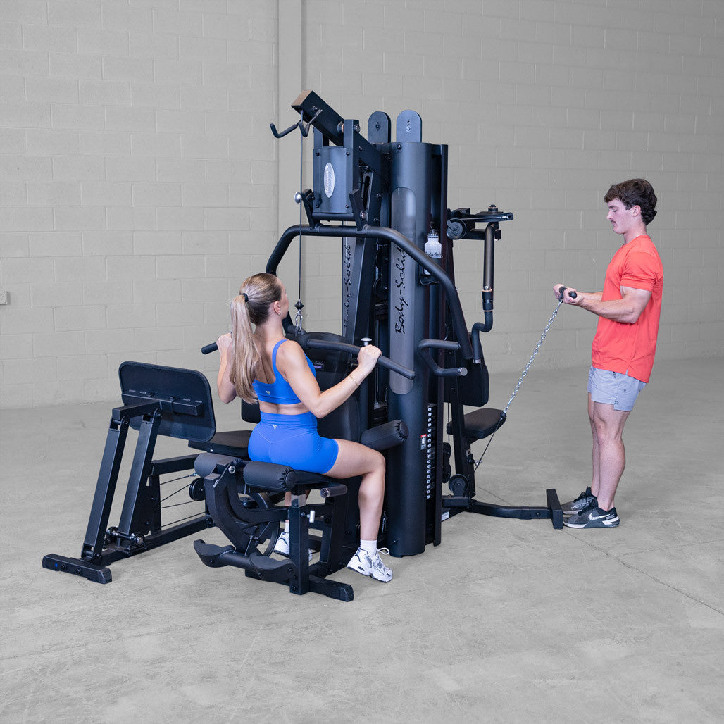 Body-Solid G9B multi-station gym, rear view showing the weight stack guide rods