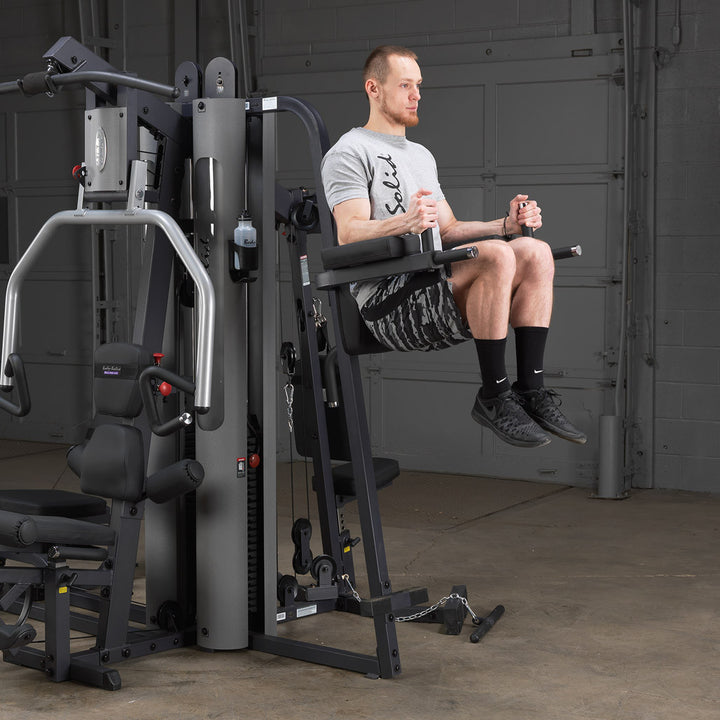 Body-Solid GKR9 knee raise and dip station shown from the side on the gym frame