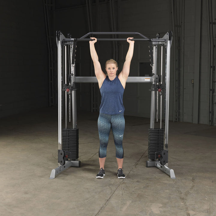 Body-Solid GDCCBAR dual press bar in use for a pressing movement