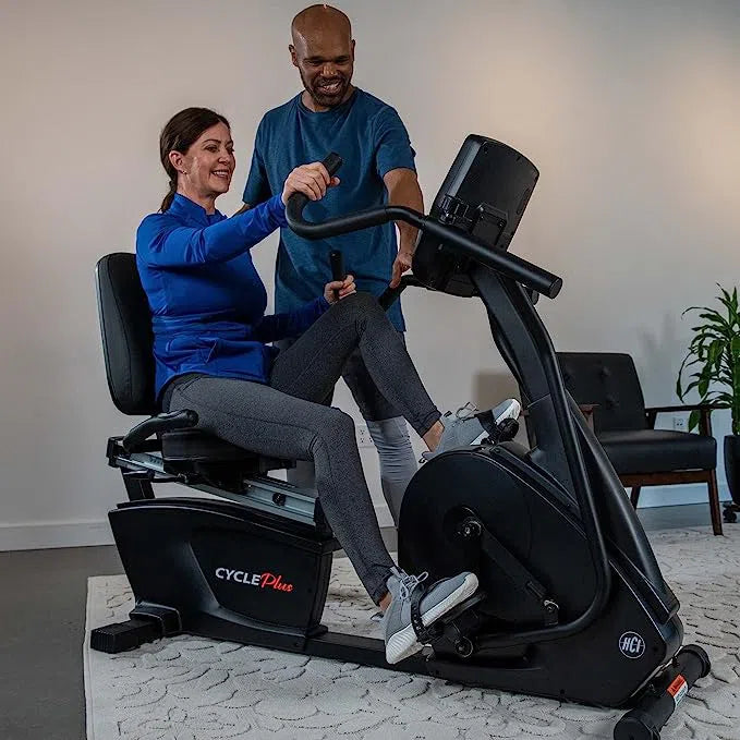 A trainer assisting a woman training on the CyclePlus Recumbent Bike with Arm Exercise CP-400