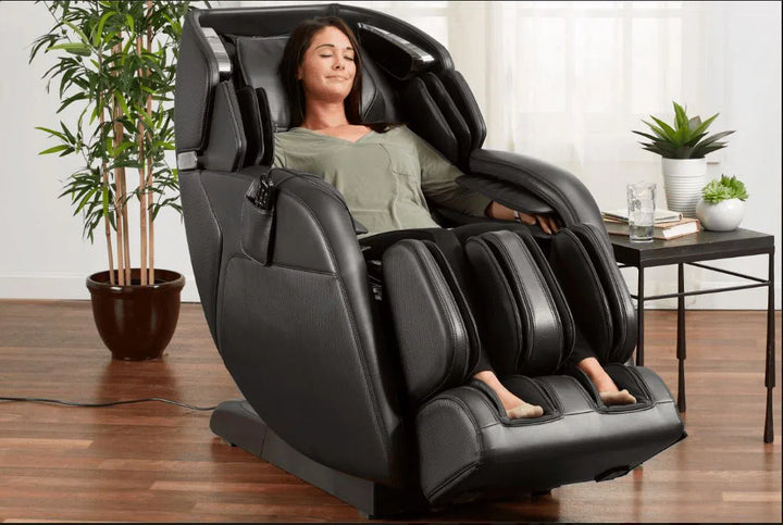 A woman relaxing in the Kenko 4D Full Body Massage Chair M673 black variant