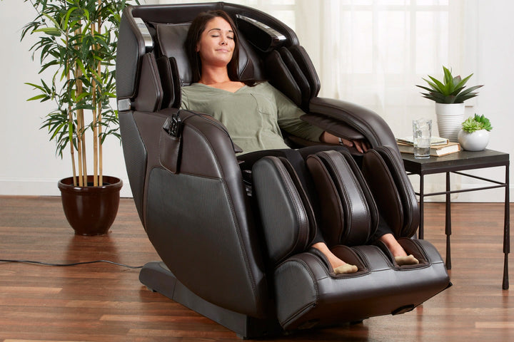 A woman relaxing in the Kenko 4D Full Body Massage Chair M673 brown variant 