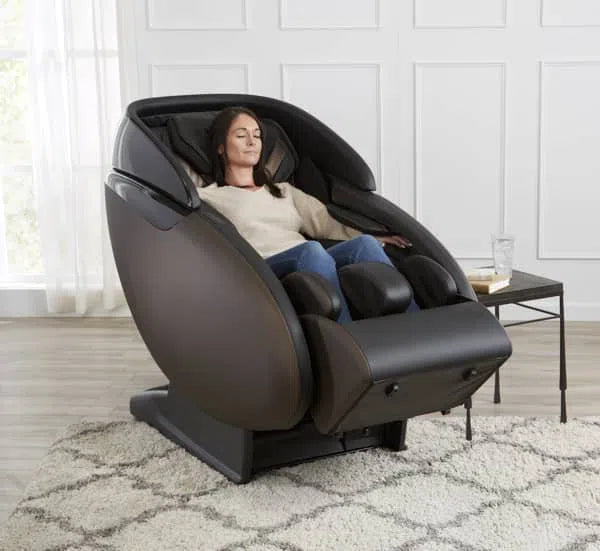 A woman relaxing in the Kaizen Full Body Massage Chair M680 brown variant 