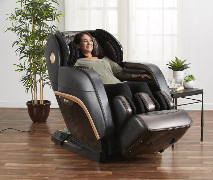 A woman relaxing in the Kokoro 4D Full Body Massage Chair M888 black variant 