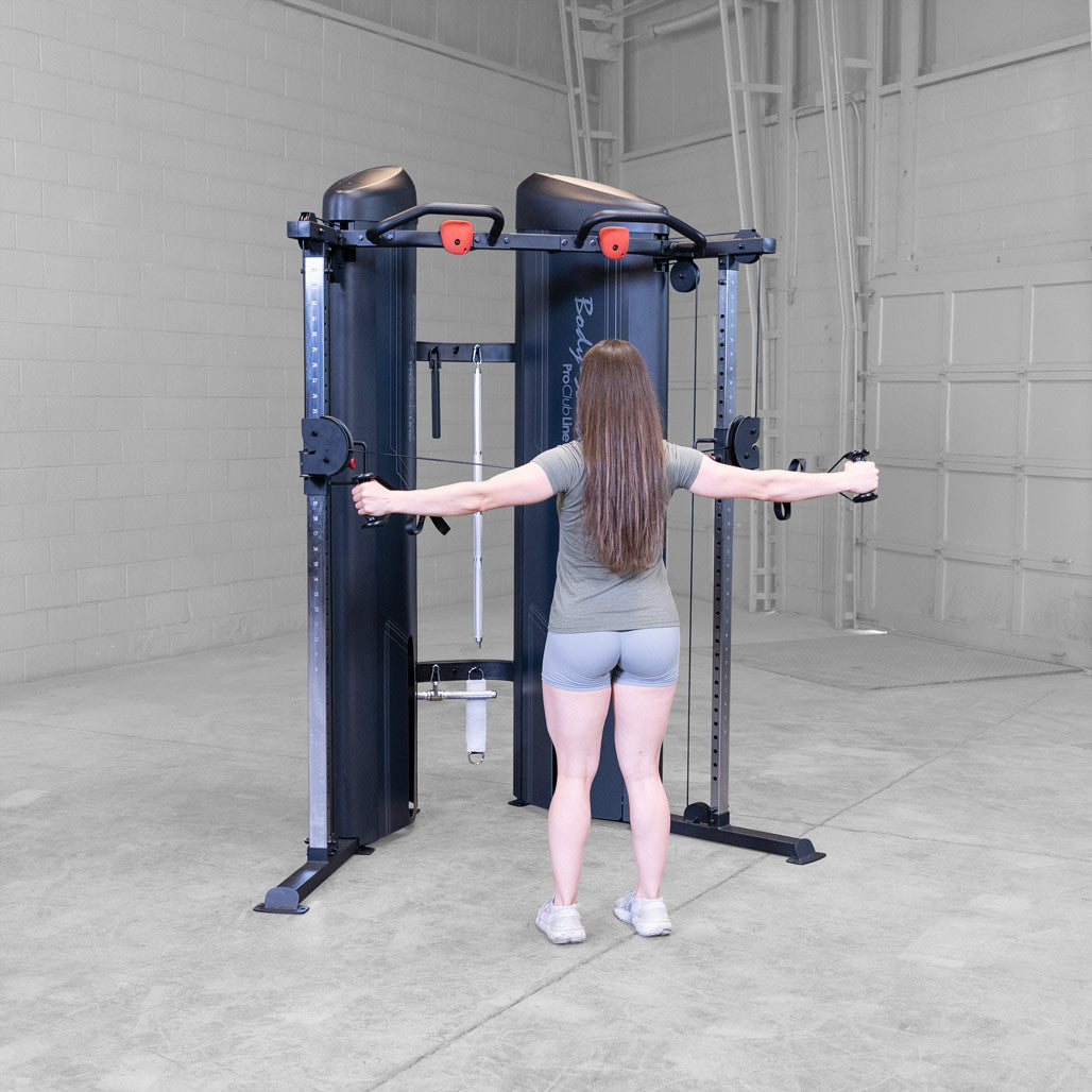 Body-Solid S2FTX functional trainer in use, cable exercise from a high pulley position
