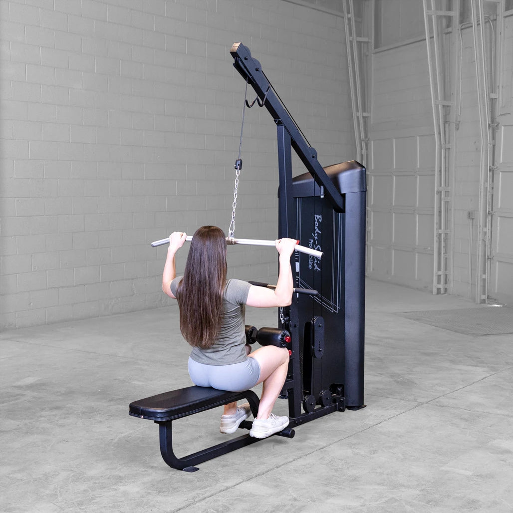 Body-Solid S2LATX seated mid row in use, with a lifter braced against the chest pad pulling the straight low row bar.