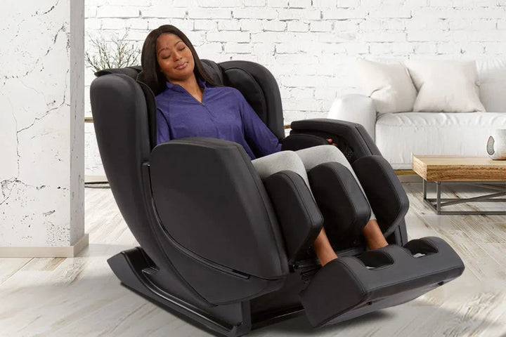 A woman relaxing in the Sharper Image Revival Zero Gravity Full Body Massage Chair