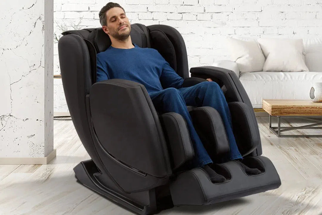 A man relaxing in the Sharper Image Revival Zero Gravity Full Body Massage Chair