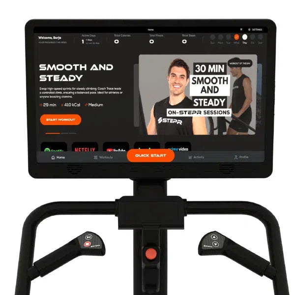 A man in a black tank top showcases the STEPR+ Stair Climber screen, featuring the Smooth and Steady 30-minute home fitness session. Its compact design allows easy access to Start Workout and monitors stats like calories burned.