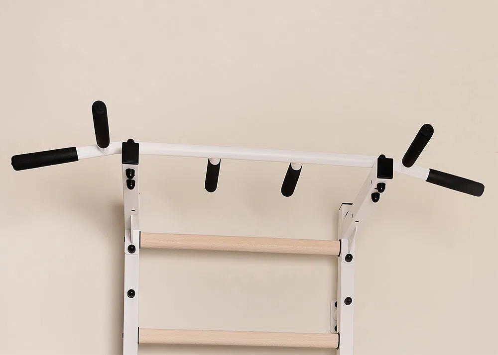 The BenchK Home Swedish Ladder (721) with a wall-mounted white pull-up bar featuring black foam grips is ideal for a home gym, providing versatile strength training options.