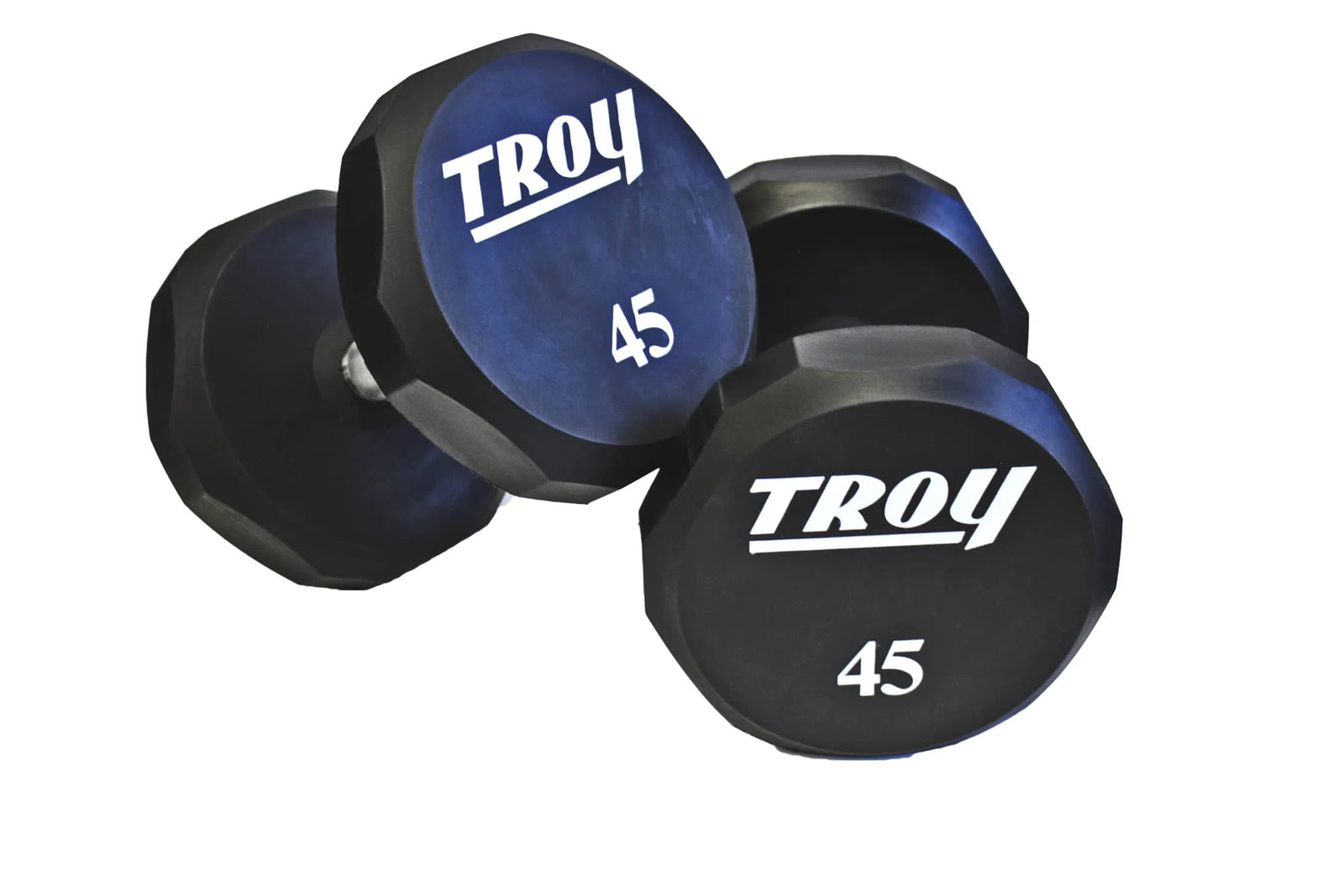 Two black hexagonal dumbbells with Troy and 45 printed on the ends rest on a white surface, symbolizing the durability of the TROY Barbell 5-100 lb Urethane Commercial Dumbbell Set w/ Rack.