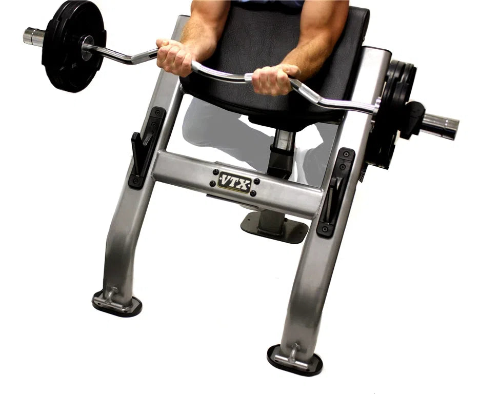 A man doing bicep curls on the Troy Barbell VTX Preacher Curl Resistance Band Bench G-CB