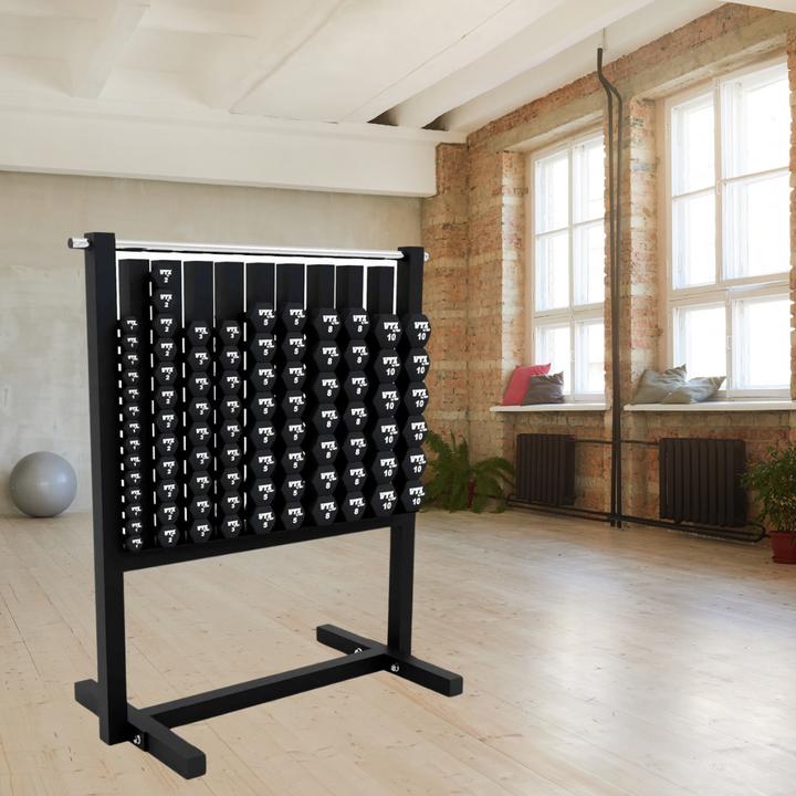 A neatly arranged rack of VTX Aerobics Neoprene Dumbbell Set (1-10 lbs.) graces a bright fitness studio with wooden floors and large windows. A yoga ball is in the corner, while cushions on the windowsill offer group fitness relaxation, showcasing a space-saving design.