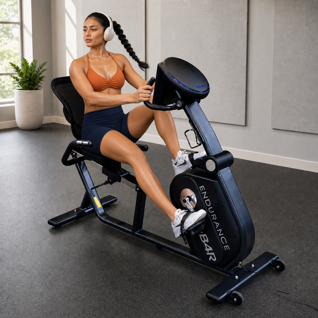 Body-Solid Endurance B4RB recumbent bike with athlete riding in a premium rehab studio