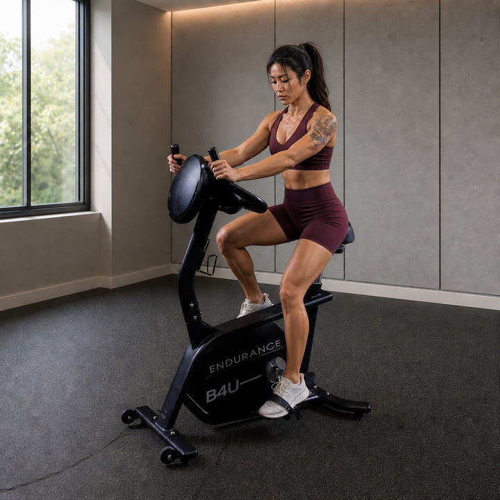 Body-Solid Endurance B4UB upright bike with athlete riding in a premium light-commercial gym
