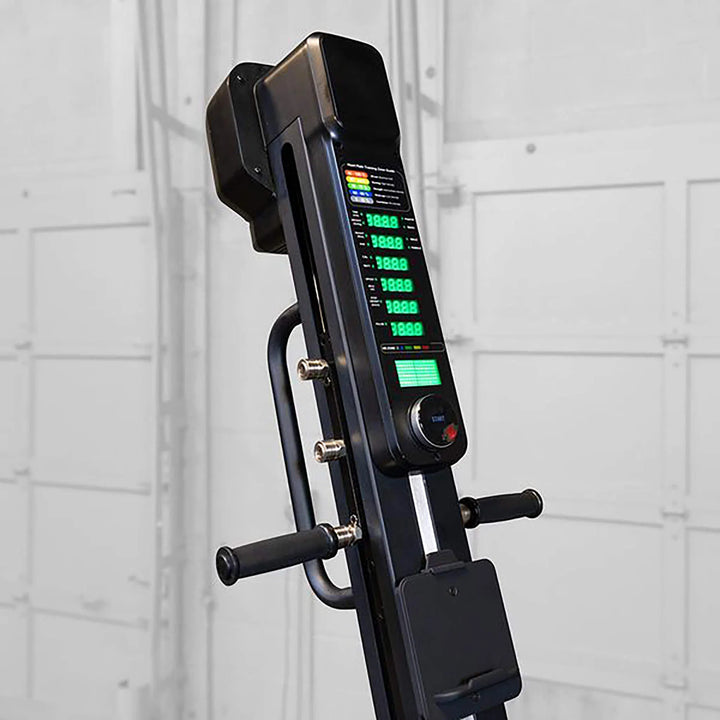 The Body-Solid Endurance Mountain Climber Machine (CL300) by Body-Solid Endurance displays a digital console with numbers, buttons, and handles for adjustable resistance across a full-body workout, set against a blurred industrial-style wall background.