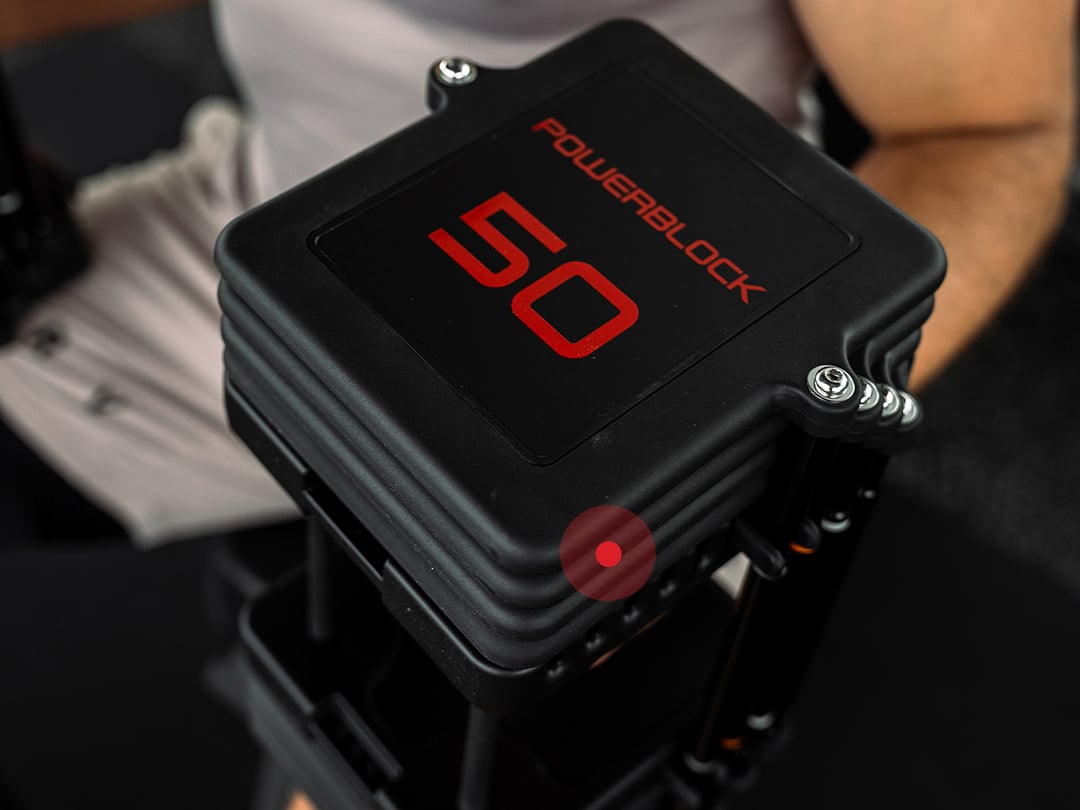 Detail of the black urethane coating on a PowerBlock Commercial Pro 100 weight plate at the 50 lb setting