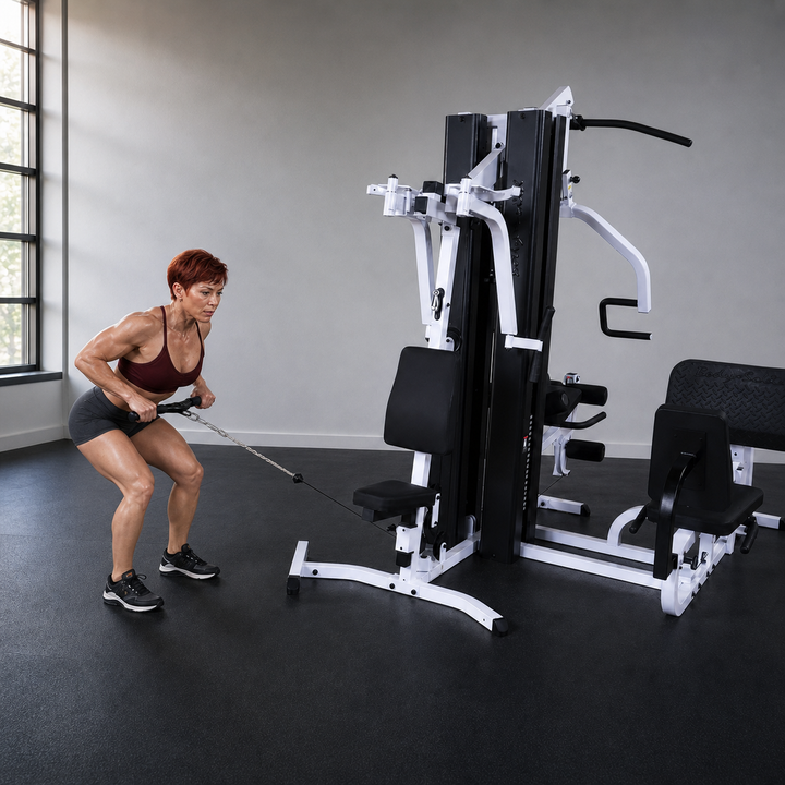 Fit model performing a standing bent-over row on the Body-Solid EXM3000LPS low pulley