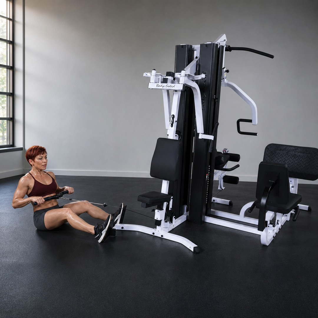 Fit model performing a seated low row on the Body-Solid EXM3000LPS row station