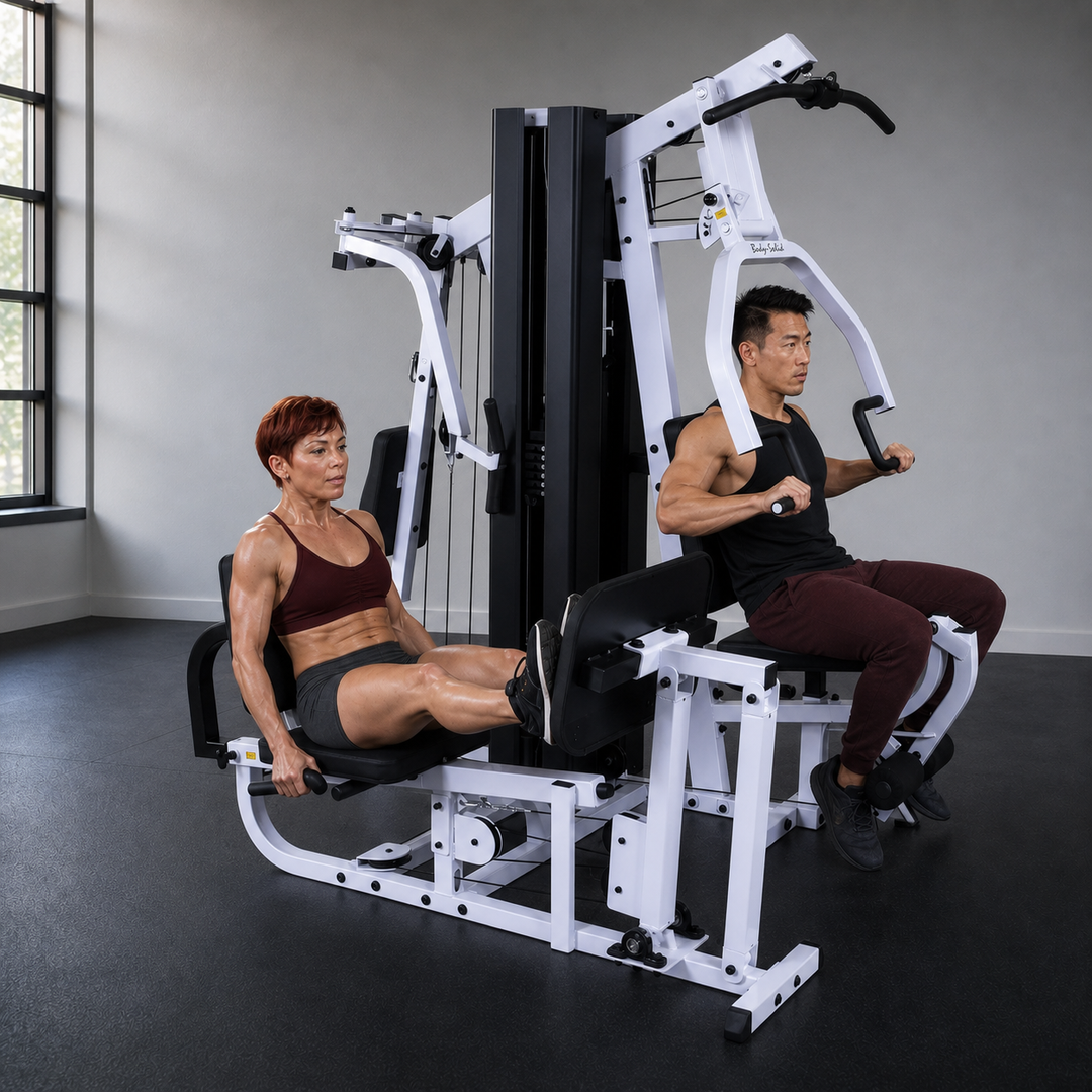 Two fit models training simultaneously on the independent Body-Solid EXM3000LPS stations