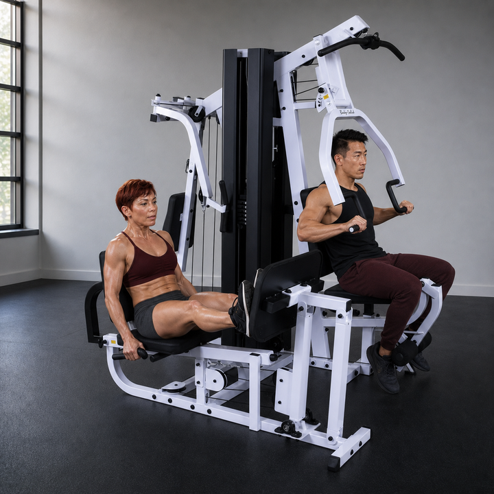 Two fit models training simultaneously on the independent Body-Solid EXM3000LPS stations