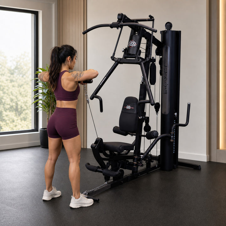Fit model performing a one-arm cable raise on the Body-Solid G6B low pulley