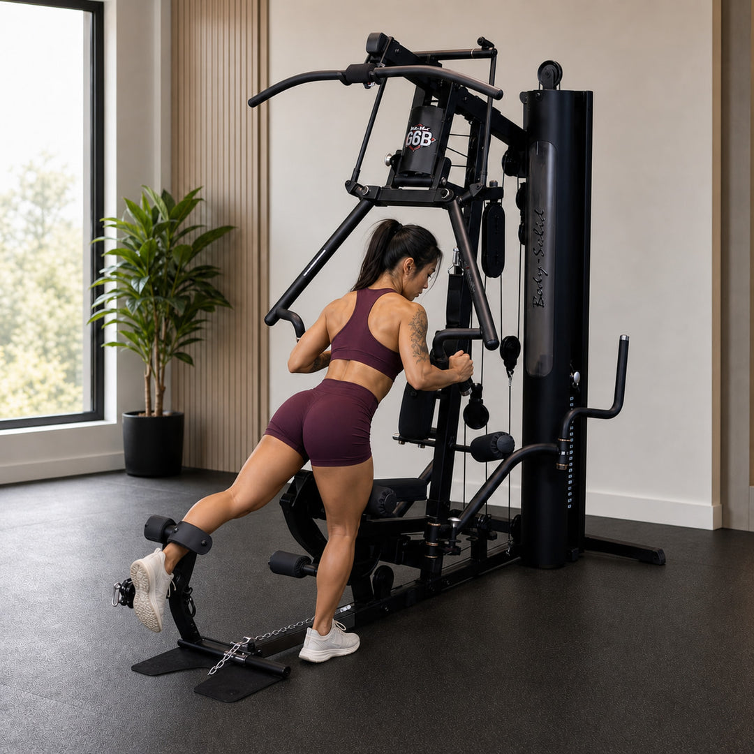 Fit model performing a standing back hyperextension using the Body-Solid G6B press arm