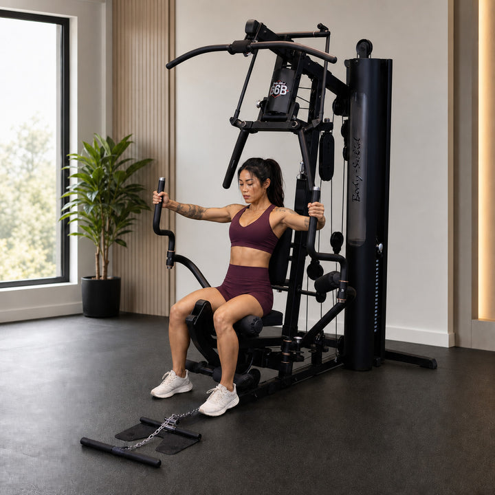 Fit model using the Body-Solid G6B Perfect Pec station with the swivel arms opened wide
