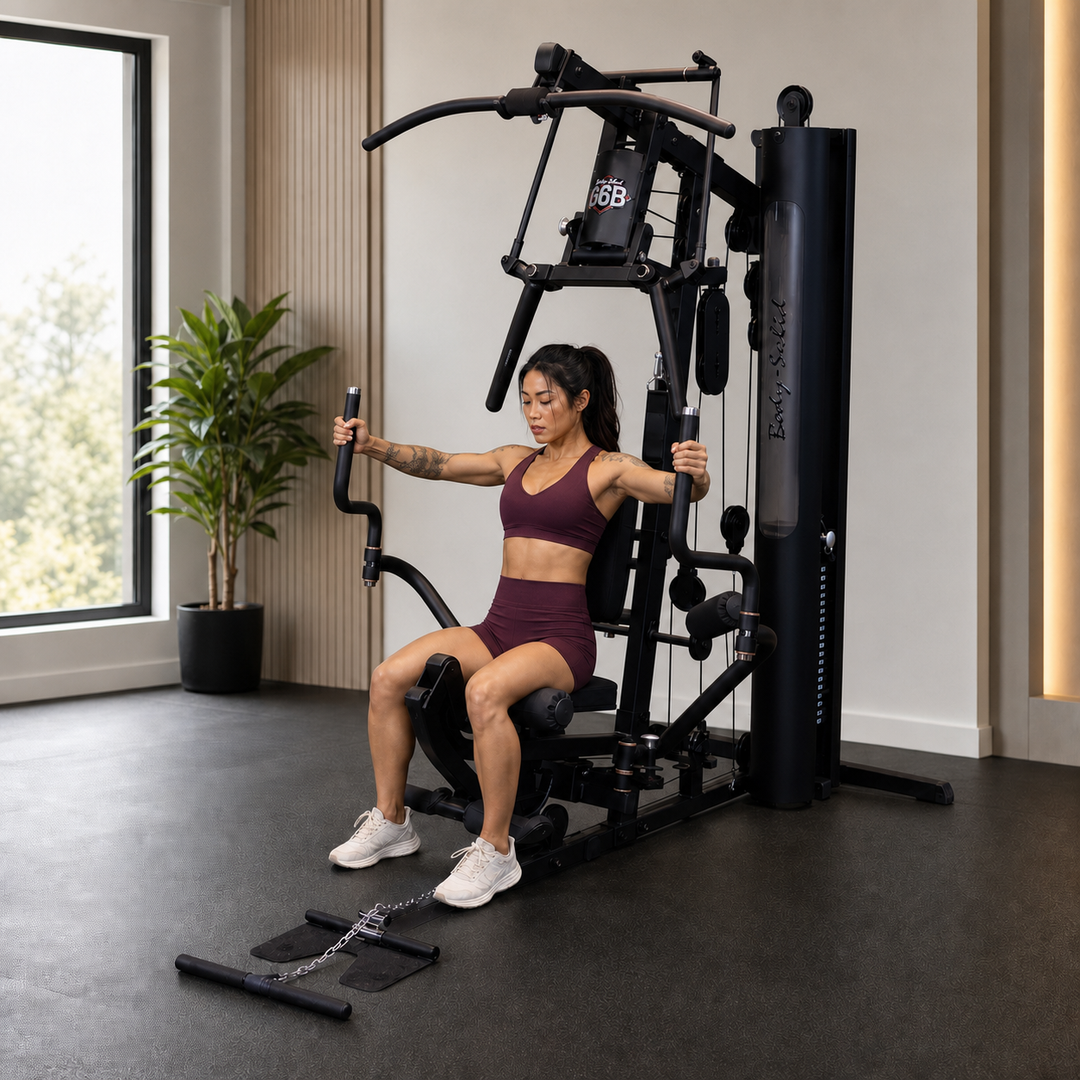Fit model using the Body-Solid G6B Perfect Pec station with the swivel arms opened wide
