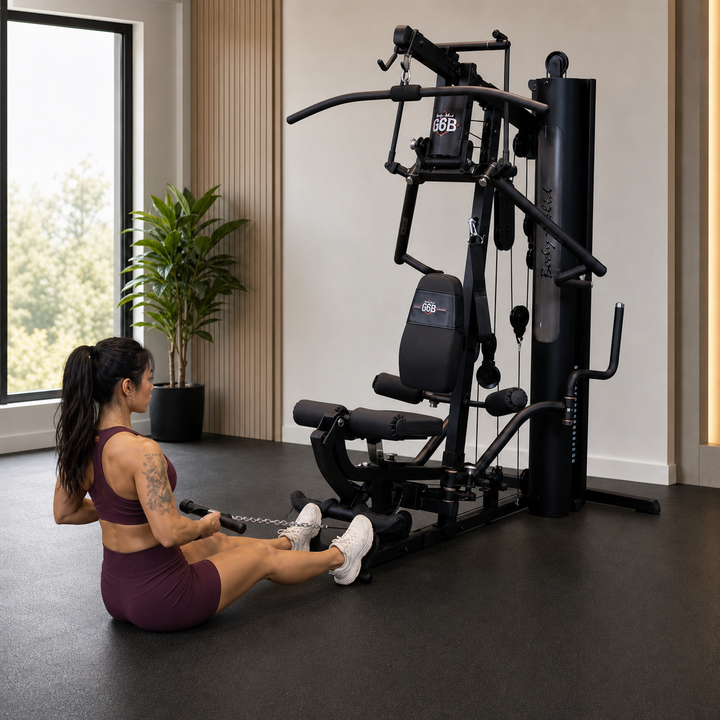 Fit model performing a seated floor row on the Body-Solid G6B low pulley