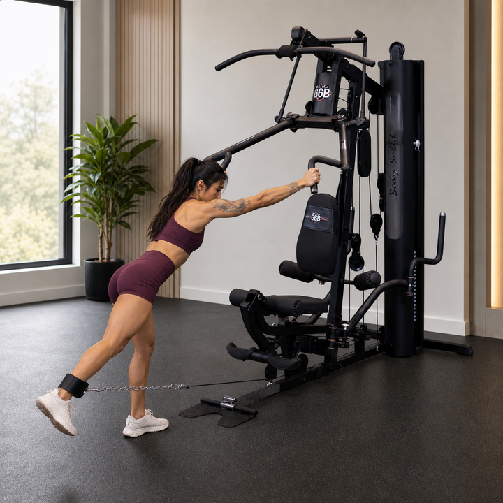 Fit model performing a standing cable glute kickback on the Body-Solid G6B low pulley