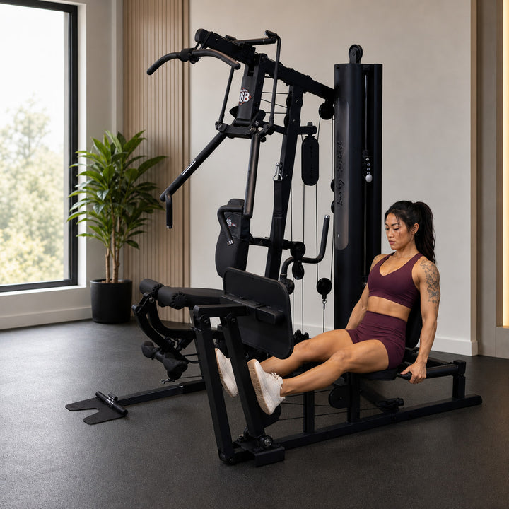 Fit model using the optional GLPB leg press attachment on the Body-Solid G6B