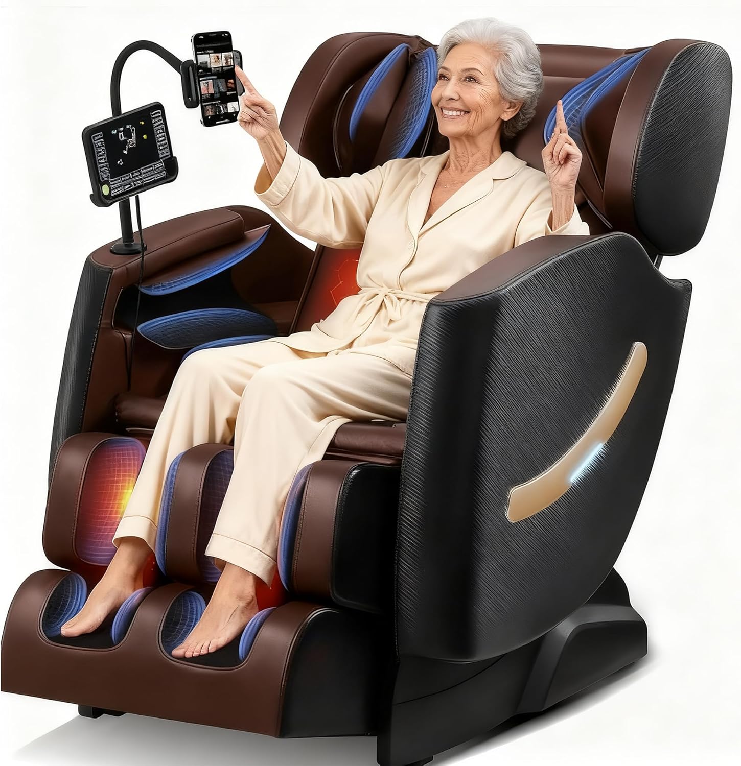 An older woman in light-colored pajamas smiles and points upward while sitting in a large, modern massage chair with built-in screens and controls.