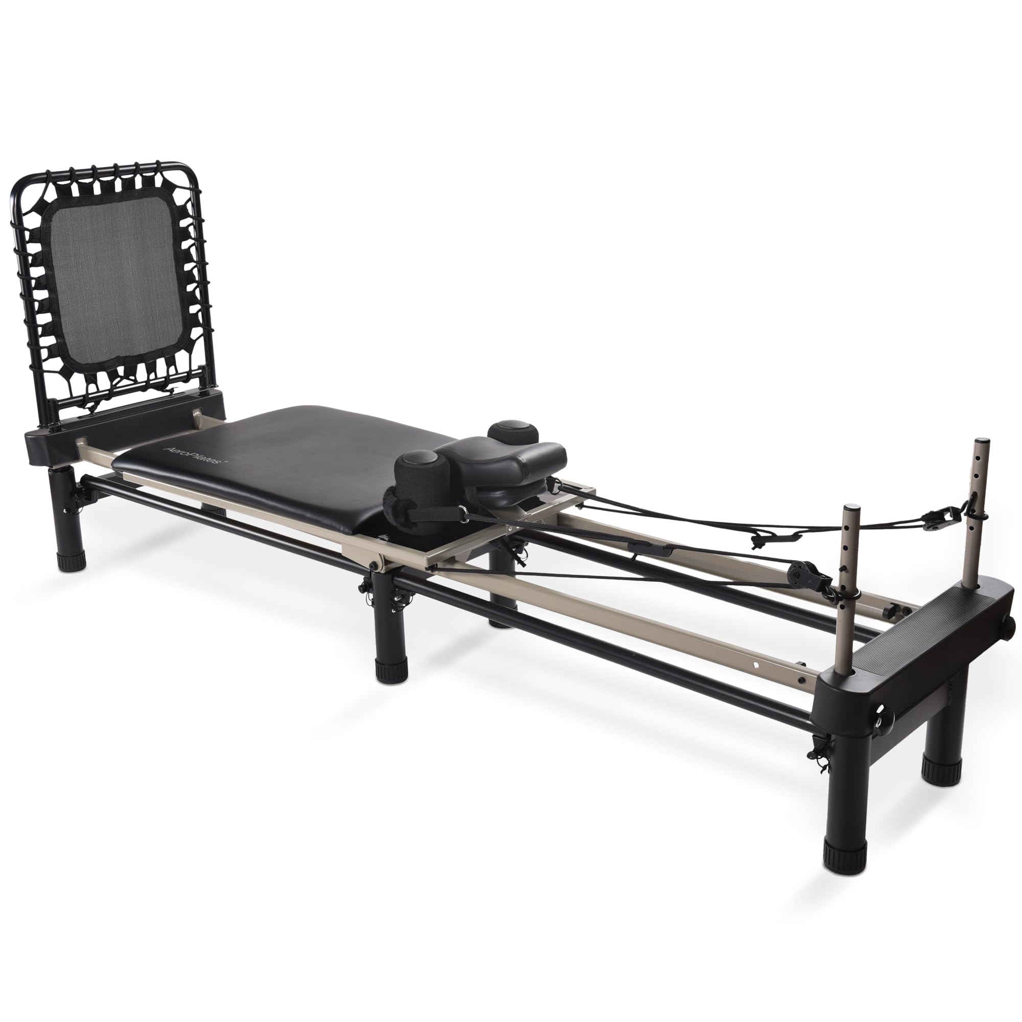 A black and silver Pilates reformer machine with a padded platform, adjustable ropes, and foot bar, designed for resistance-based exercise, is shown against a white background.