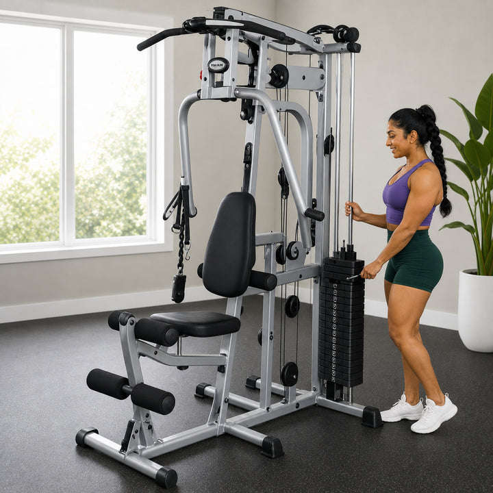 Fit model preparing the Body-Solid Powerline P2X home gym for a cable workout