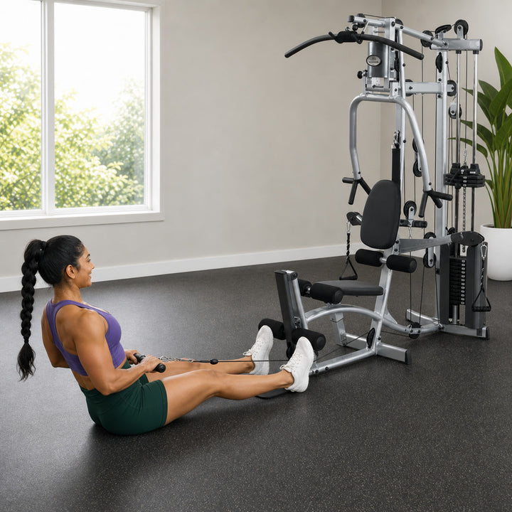 Fit model performing a seated floor row on the Powerline P2X low pulley station